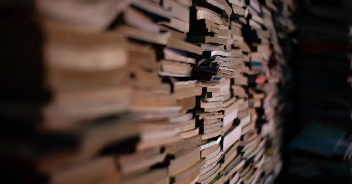 A tall wall of stacked books with plain spines
