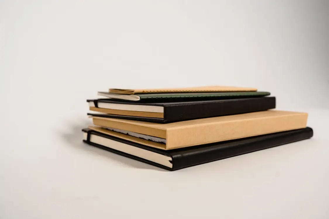 A stack of plain notebooks tied with string