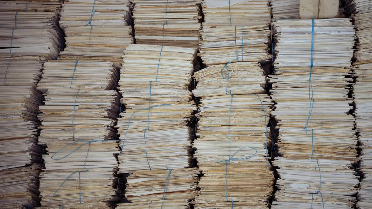 Bundles of paper tied with blue string